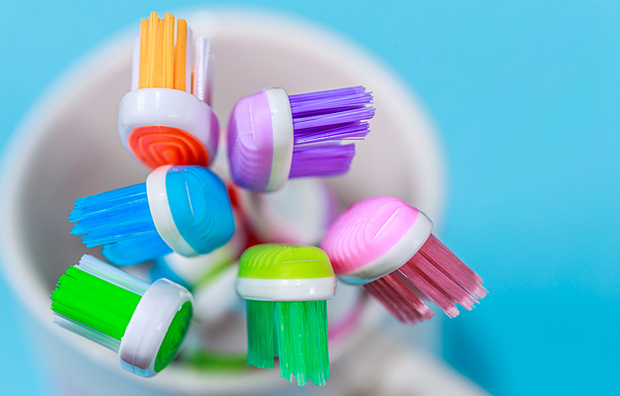 A cup full of toothbrushes.