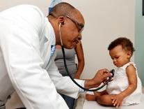 Dr. Michael DeBaun with a patient