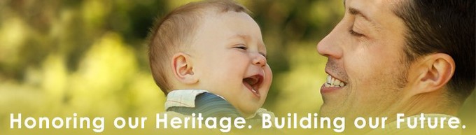 Banner: Hispanic man holding a baby with the caption, "Honoring our Heritage. Building our Future."