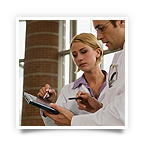 Two healthcare professionals interacting with a tablet computer.