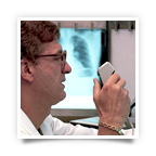 A doctor speaks into a device, which translates his words into text. A doctor speaks into a device, which translates his words into text.