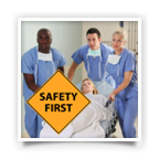 Studying medical team wheeling a patient with a sign saying safety first