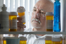 Man looking at prescription drugs