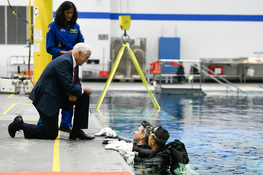 Vice President Mike Pence speaks with astronauts training at the Neutral Buoyancy Lab (NBL)