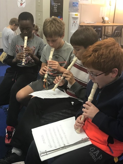 Upper grade music students playing recorders