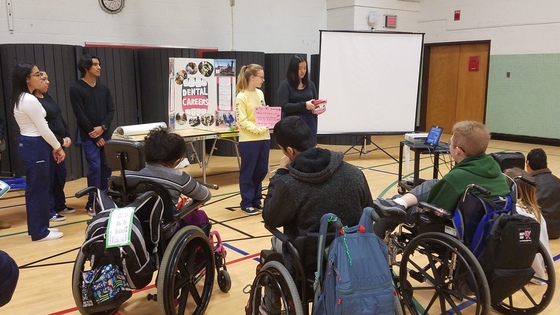 Picture of students teaching oral hygiene to other students 
