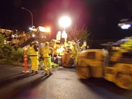 Construction paving crew working at night