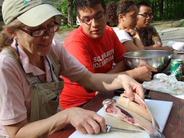 Theresa Stabo demonstrating how to filet a fish 