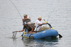 two men in a raft on the river