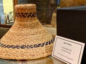 pale cedar bark hat with two rows of dark accents showing Lingit name on label