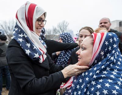 Two women wearing American flag headscarves at the Women's March in Washington