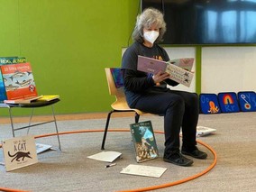 A librarian reads a book during storytime