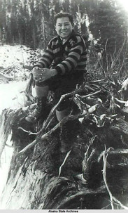 Benny Benson wears a striped sweater and poses against a snowy background