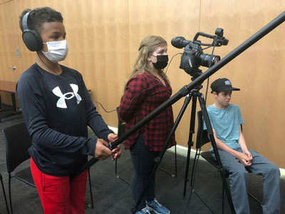 Tchabo Acemah, Alanna Zellhumber and Hunter Schall take part at student video workshop at the Alaska State Museum 