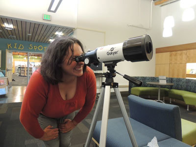 Elizabeth Kleweno looks through telescope