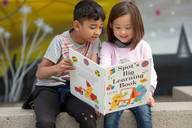 Elementary boy and girl reading