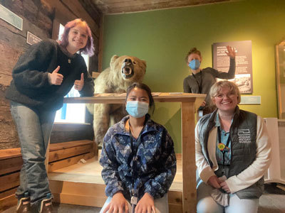 Kodiak History Museum staff pose in the permanent gallery