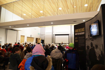 A large crowd of residents awaits a four-person panel, Family Stories at Mendenhall Valley Public Library