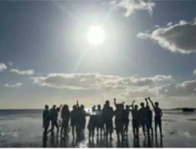 Students volunteer by collecting trash at Mokauea during a reef walk.