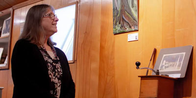 Cindi Lagoudakis looks at a painting at Clausen Museum