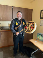 Chuck Miller stands with his drum at the Sitka Public Library after sharing traditional stories for Elizabeth Peratrovich Day.