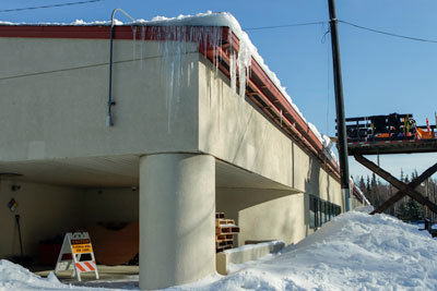 Rainproof Roofing is continuing to remove snow and ice off of the library roof of Klatt Elementary School