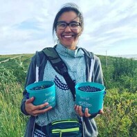 Nicolette Corbett holds two containers of blueberries