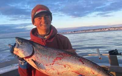 Sam Schimmel on boat with salmon