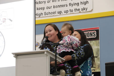 Atkiq Michelle Ilutsik-Snyder holds her daughter as she talks about language revitalization efforts in Igiugig and around the region