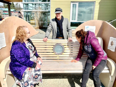 Community members gather  at the Homer Public Library for a ceremony to celebrate the installation of the Loved & Lost Memorial Bench