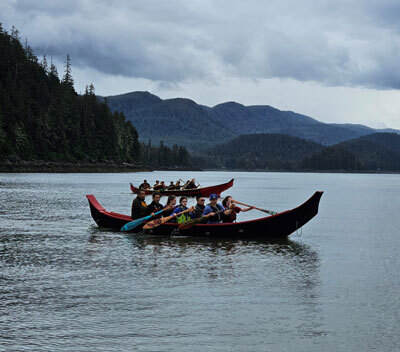 paddlers in dugout canoes