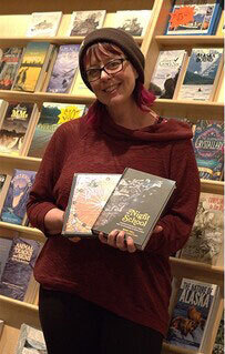 Nolan Center Director Cyni Crary displays some of the gift shop's new nonfiction reads