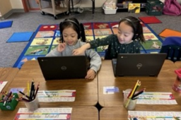 two children on laptops