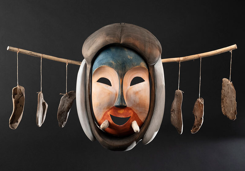 painted wooden mask with tusks 