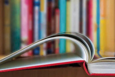 closeup of book with stacks in background