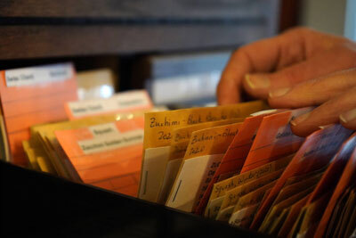 A person peruses packets of seeds in the Soldotna Seed Library at The Goods Sustainable Grocery on Thursday, Feb. 1, 2024