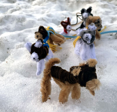 Example of sled dogs you can make posed in the snow
