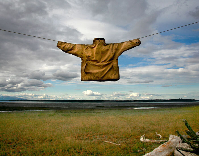 jacket hangs with arms stretched wide against expansive landscape