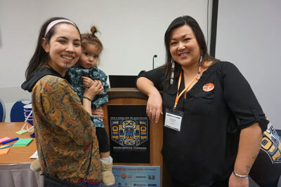 Annauk Olin, holding her daughter, Tulġuna T'aas Olin, and Rochelle Adams