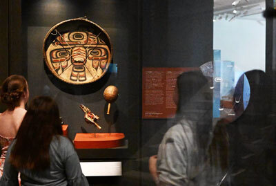 Visitors to the Denver Art Museum look at “Drum (Gaaw),” a cultural item from the Tlingit and Haida Indian Tribes of Alaska