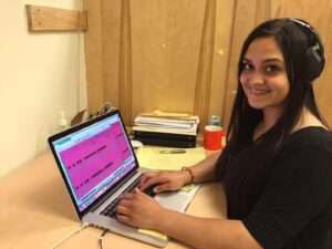 Rebecca Pruitt edits audio files at the Alutiiq Museum.