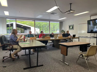 Members of the Sitka School Board and Sitka School District superintendent Deidre Jenson (left) discuss staffing cuts