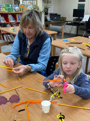 Some evacuees to the Tri-Valley Community Library helped with the summer reading program on Tuesday.