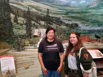 Denali National Park curator Kim Arthur (Diné) and archaeologist Crista Cummings in the wolf science section of the Denali Visitor Center