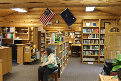 Janet Bentley sits in the Cooper Landing Community Library