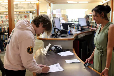 Sitka High Freshman Finn Mullin applies for a card at the Sitka Public Library.