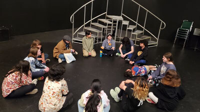 kids sit in circle for workshop led by Kylie Ferguson