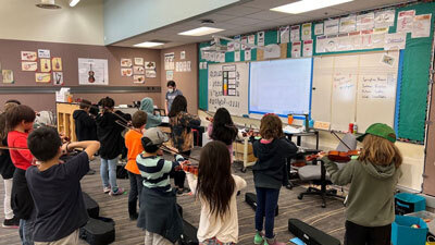strings students practice in classroom