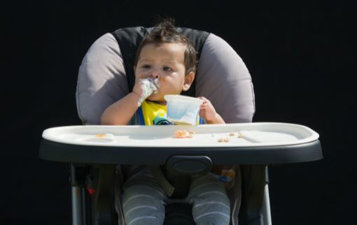 Toddler eating plain yogurt