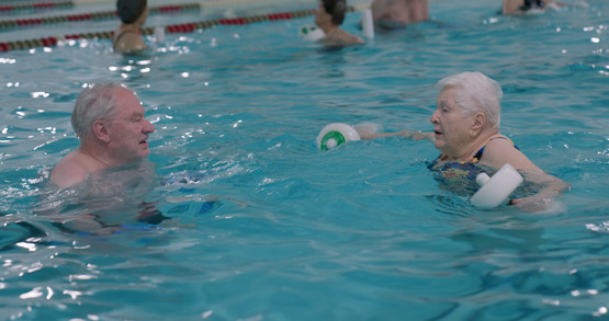 Maurine swims and catches up with Joel at a recent water aerobics class at the YMCA in Anchorage.